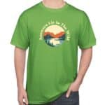 Green t-shirt with circular mountain, forest, and river graphic surrounded by the words “Answers Lie in the Wild” on the chest.